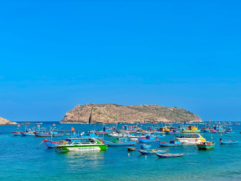 The waters at Hon Kho Beach shine with a vibrant, gemstone-like blue